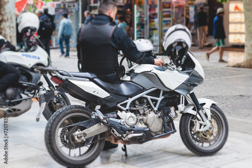 Police squad formation on duty riding bike and motorcycle, maintain public order in the european city streets, group of policemen patrol on motorbikes with "Police" logo emblem on uniform, Europe