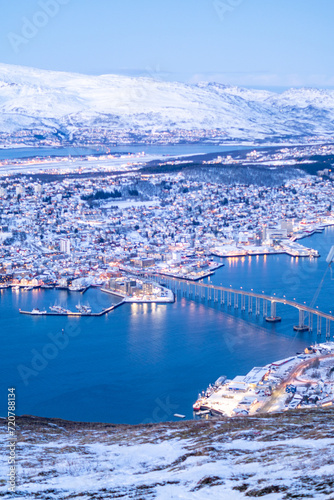 Fjellheisen viewpoint over tromso city in north of norway in winter time with the sunset over the fjords