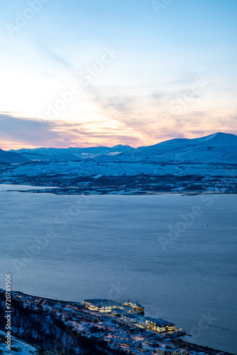 Fjellheisen viewpoint over tromso city in north of norway in winter time with the sunset over the fjords photo