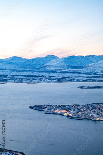 Fjellheisen viewpoint over tromso city in north of norway in winter time with the sunset over the fjords photo