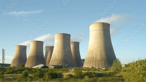 Smoke rising from incredibly tall cooling towers at power station in Ratcliffe On Soar. Air pollution during production of electric energy at coal fired power plant. Stunning industrial infrastructure photo