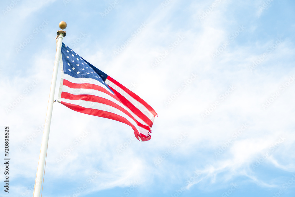 american flag waving against sky