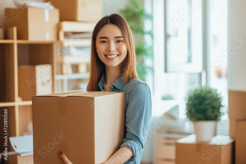 Woman carrying boxes in her new apartment, home relocation concept