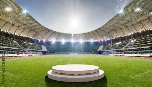 podium in the center of a stadium, surrounded by rows of empty seats and light flashes. The podium is simple and perfect to show your product, the playground of grass inside the soccer football © blackdiamond67