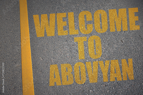 asphalt road with text welcome to Abovyan near yellow line. photo