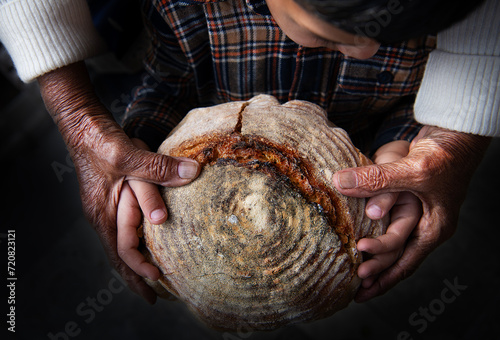 Grandma and grandchild holding handmade artisan bread  photo