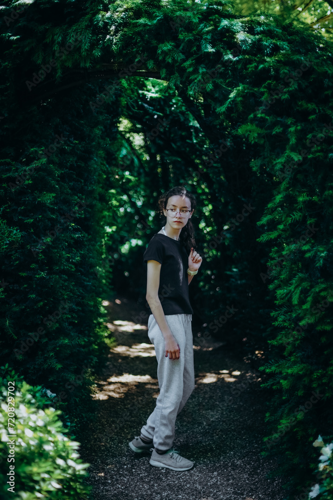 Portrait of a teenage girl in a botanical garden on a path with an arch. Portrait of a teenage girl in a botanical garden on a path with an arch.