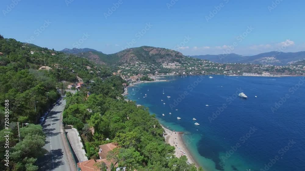 Traffic on mountain road and sea bay with vessels sail near coastal town Traffic on mountain road and sea bay with vessels sail near coastal town