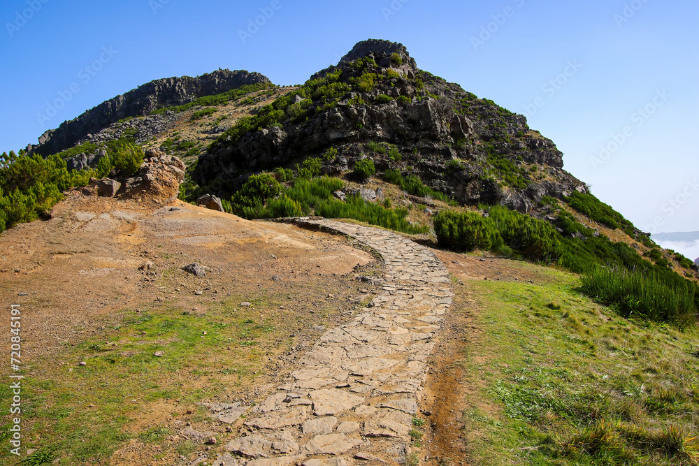 Naklejka premium Paved footpath of the PR 1.2 trail climbing to the Pico Ruivo, the highest mountain peak on Madeira island (Portugal) in the Atlantic Ocean