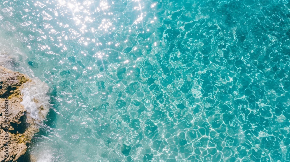 Sparkling waves dance upon a tranquil aqua sea, reflecting the warmth of the sun in a fluid display of turquoise beauty