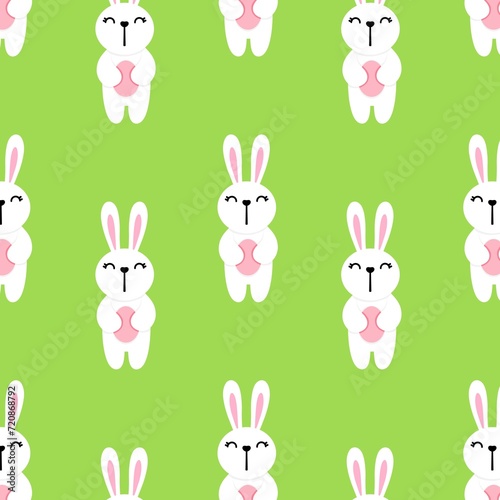 White rabbit holding an egg in his hands on a green background repeating pattern