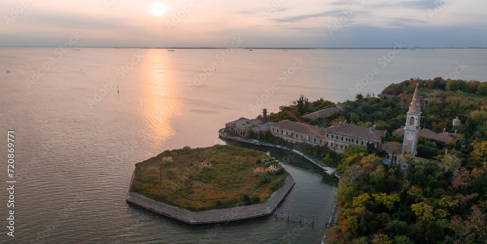 Aerial view of the plagued ghost island of Poveglia in the Venetian lagoon, opposite Malamocco along the Canal Orfano near Venice, Italy.