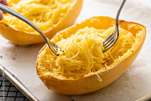 Spaghetti squash baked and pulled apart ready to eat on a baking pan photo