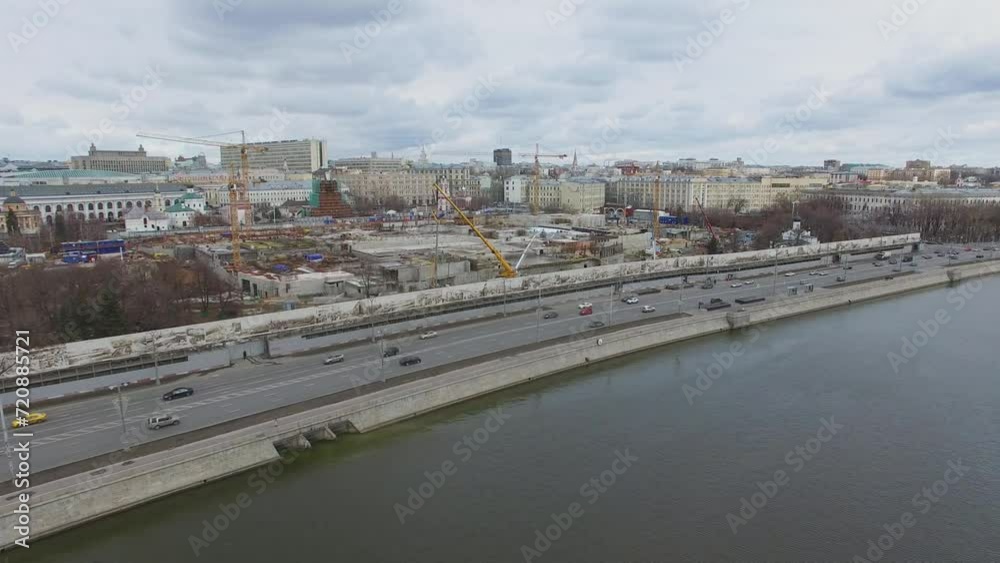 Transport traffic on river quay near large construction site Transport traffic on river quay near large construction site