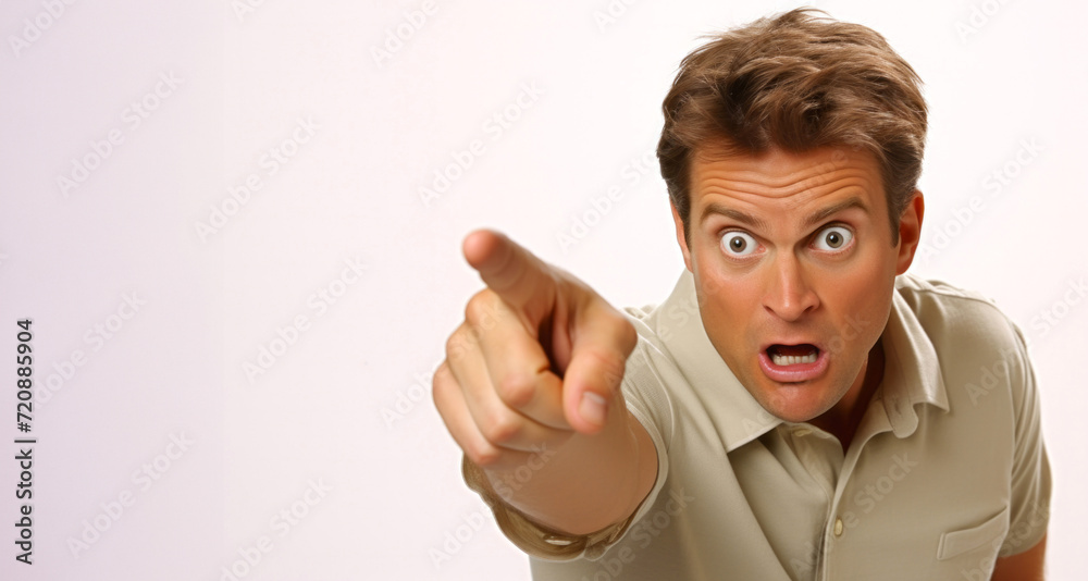 Angry young man pointing his finger at the camera on a white background Angry young man pointing his finger at the camera on a white background