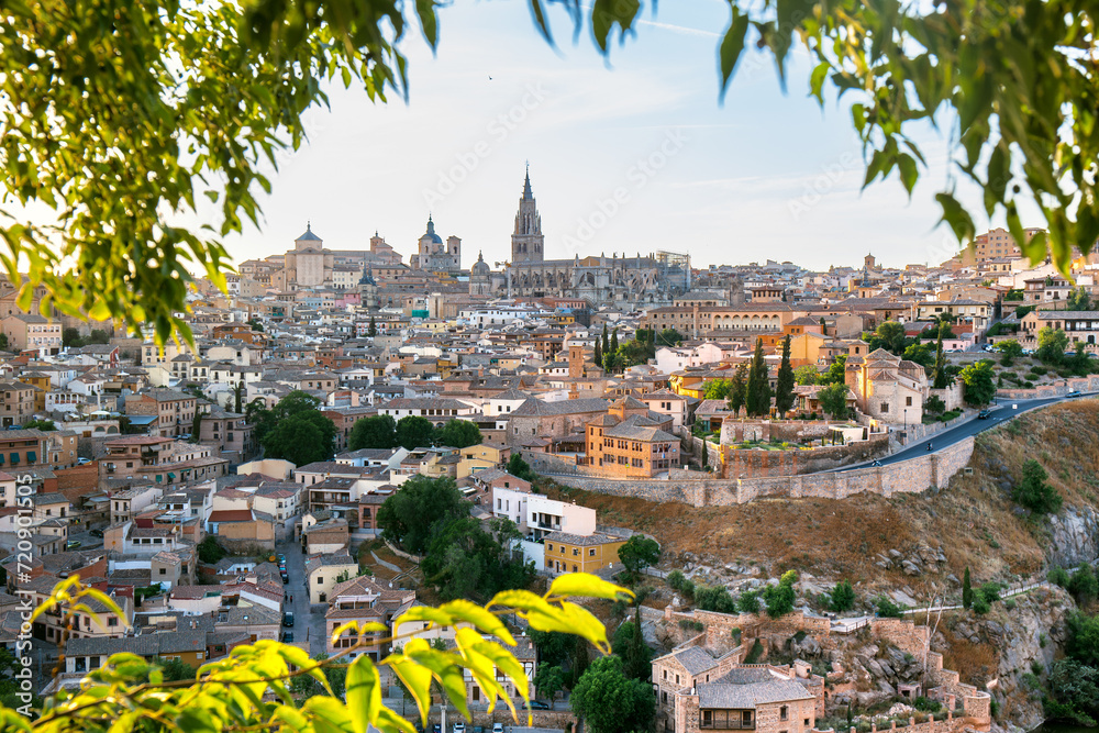 Panoramic view of Toledo in a green foliage frame, Spain - obrazy, fototapety, plakaty 