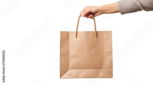 Close up female holds in hand brown clear empty blank craft paper bag isolated on transparent and white background.PNG image.
