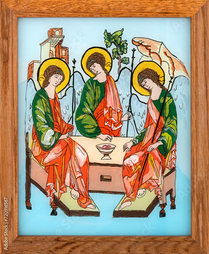 Icon painted on reverse glass in the naive orthodox style of Eastern Europe depicting the Holy Trinity. Framed icon.