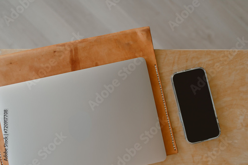  Computer laptop and mobile phone work set on wooden table in concept of home office freelance and entrepreneur.