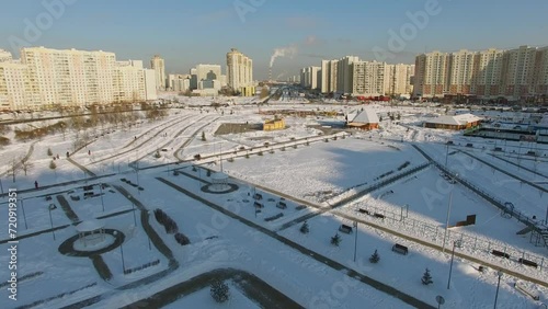 Artem Borovik park near street with traffic at sunny winter day photo