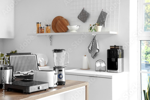 Set of modern appliances on wooden table in contemporary kitchen