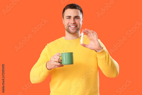 Young man with cup of tea a...