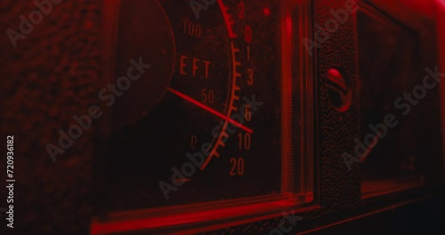 A vintage recorder volume indicator in the red blinking light