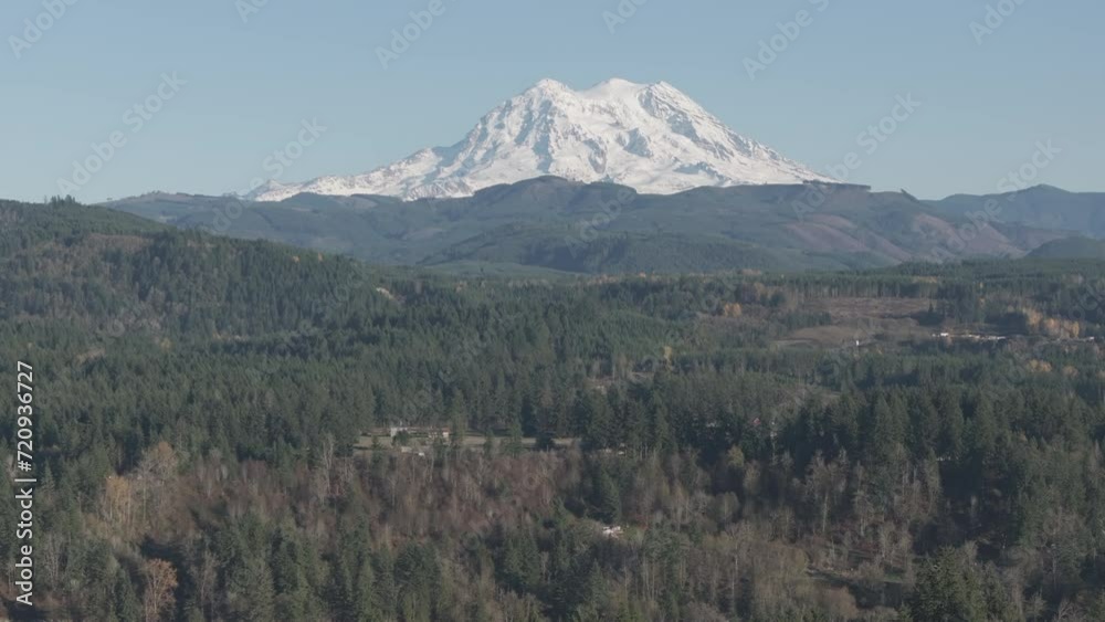 Ungraded 4k wide-angle push-in aerial drone footage of Mt. Rainier under light blue sky on a sunny day in Washington State. Ungraded 4k wide-angle push-in aerial drone footage of Mt. Rainier under light blue sky on a sunny day in Washington State.