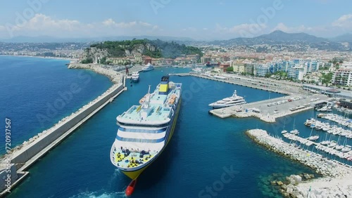 Cityscape with ferryboat Mega Express Two sails in port of Nice 