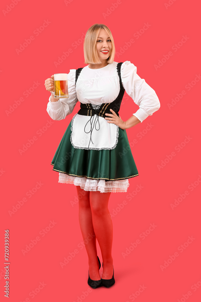 Happy woman with beer celebrating St. Patrick's Day on red background Happy woman with beer celebrating St. Patrick's Day on red background