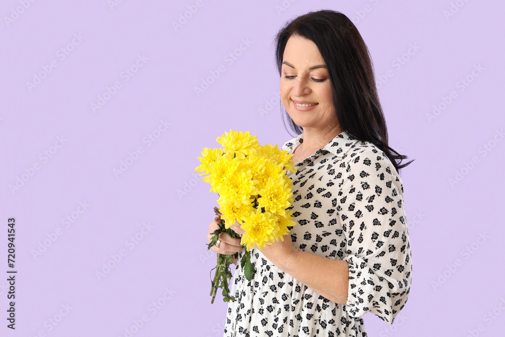 Beautiful happy mature woman with bouquet of flowers on purple background. International Women's Day Beautiful happy mature woman with bouquet of flowers on purple background. International Women's Day
