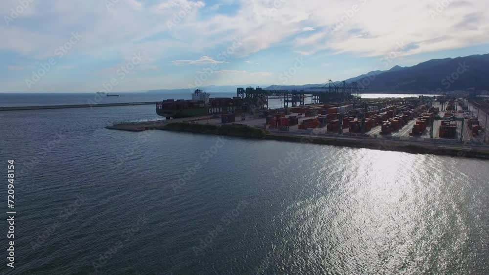Seascape and container terminal Voltri Europa with barge on moorage Seascape and container terminal Voltri Europa with barge on moorage