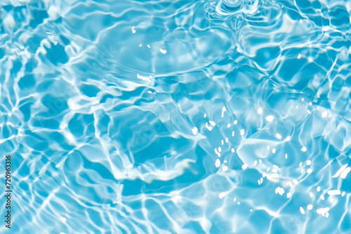 Bluewater waves on the surface ripples blurred. Defocus blurred transparent blue colored clear calm water surface texture with splash and bubbles. Water waves with shining pattern texture background. © Water 💧 Shining 📸