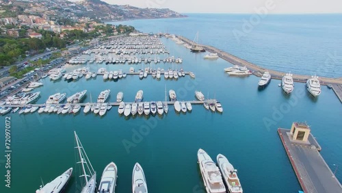 Many vessels on moorage in Sole port near coastal city at summer 