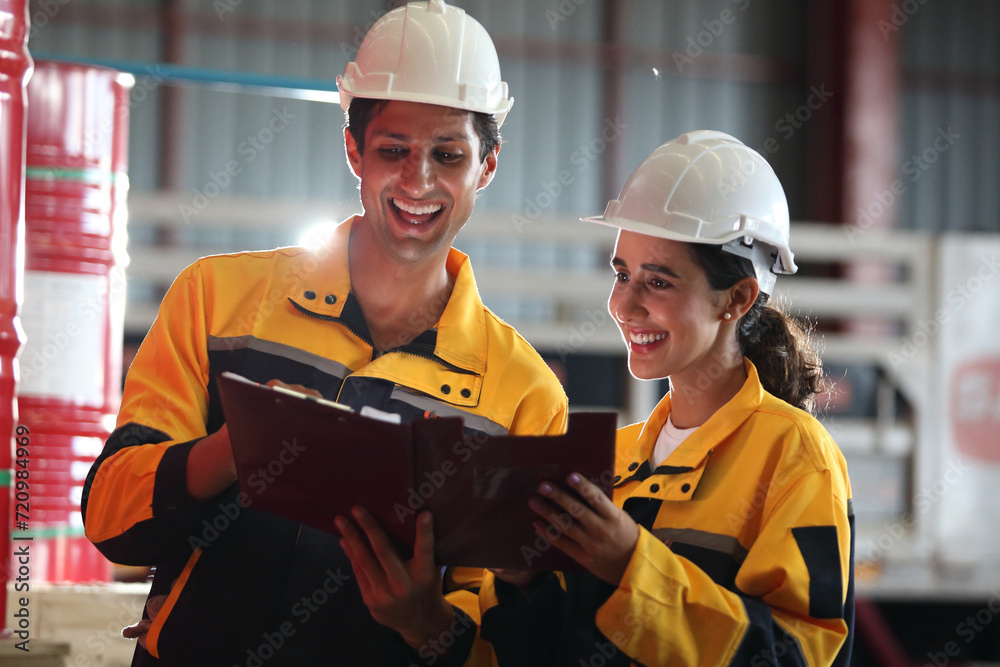 worker or engineer working in factory with safety uniform , safety hat and safety glasses , image is safety concept or happy workplace worker or engineer working in factory with safety uniform , safety hat and safety glasses , image is safety concept or happy workplace