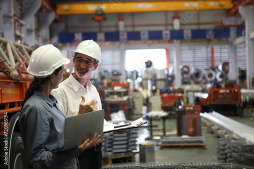 worker or engineer working in factory with safety uniform   safety hat and safety glasses   image is safety concept or happy workplace