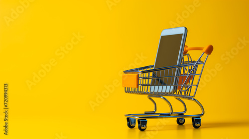 online shopping, shopping cart with cellphone on yellow background 