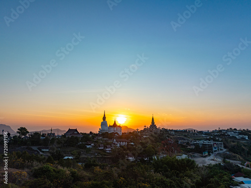 Aerial view beautiful sunrise above Big White Five buddha Statues in Wat Phra That Pha Son Kaew temple at Phetchabun Thailand..beautiful and famous landmark in Thailand. sea of mist background. .