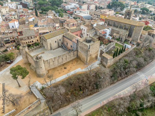 Aerial view of Calonge town medieval castle with inner garrison courtyard surrounded by walls with crenallations and quare old tower, residential palace. Venue for music festival in Catalonia Spain