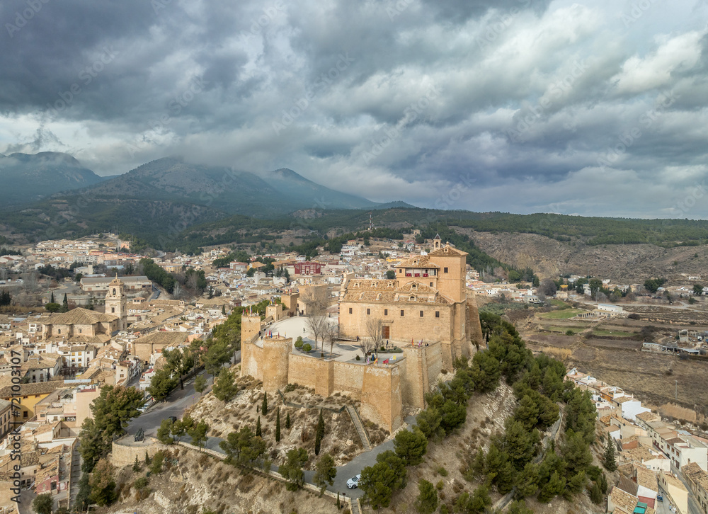 Aerial view of Caravaca de la Cruz castle and medieval town in Southern Spain with stormy cloudy sky