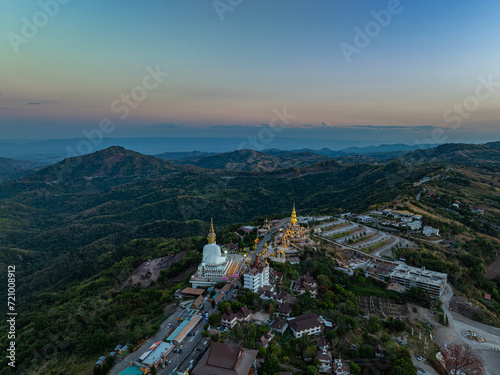 Aerial view amazing Big White Five buddha Statues in sunset. beautiful golden pavilion of Wat Phachonkeaw decorate with jewels and stones on the hill very beautiful and famous landmark in Thailand. photo