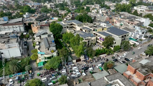 Aerial profile view of Cheema Heart Complex with lots of visitors beside a busy jammed street situated at Gujranwala, Punjab, Pakistan. photo