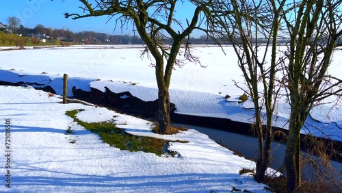 Dutch winter countryside floodplain landscape covered with white snow photo