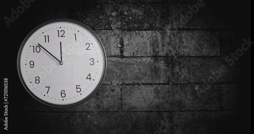 Image of clock ticking over brick wall background