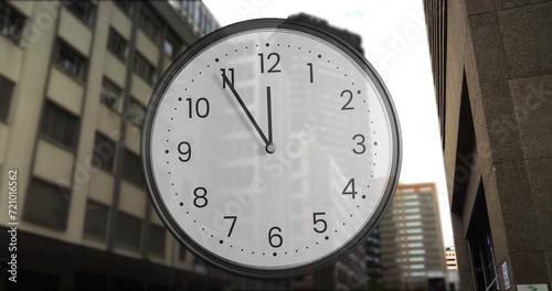 Image of clock ticking over cityscape