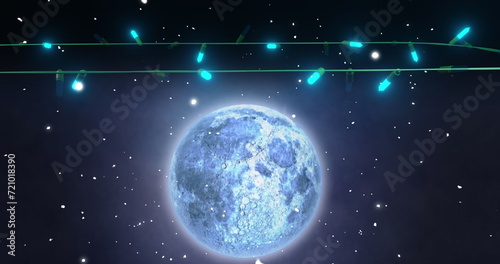 Blue christmas string lights flashing over falling snow and full moon in night sky