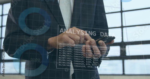 Image of statistics and data processing over caucasian businessman smiling in office photo