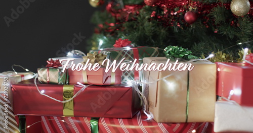 Frohe weihnachten test over christmas presents and lights under decorated tree