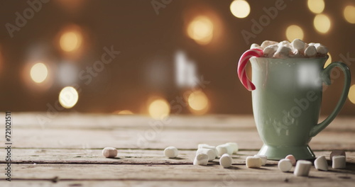 A cozy mug of hot chocolate adorned with marshmallows on a wooden table