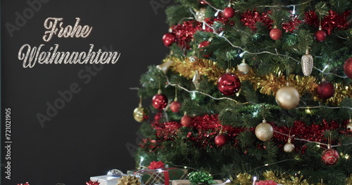 Frohe weihnachten text with decorated christmas tree and gifts on black background